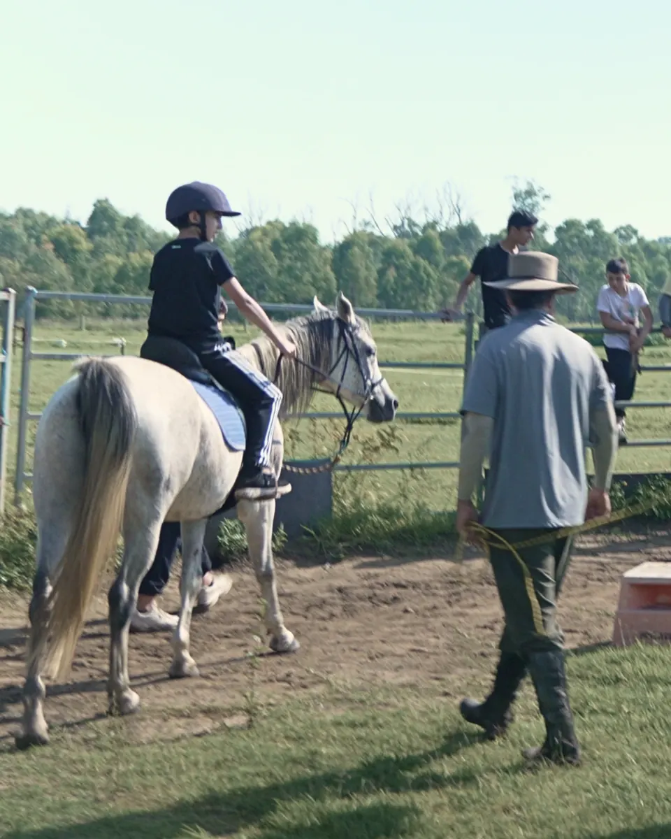 A student horse riding on an outdoor excursion