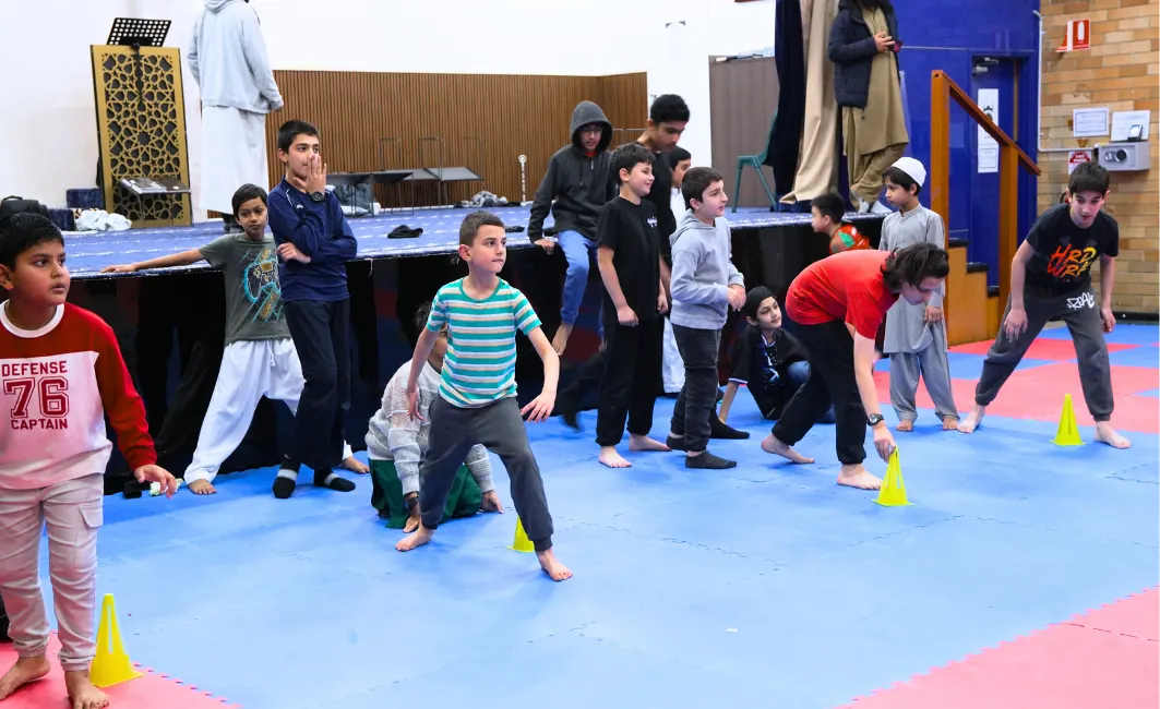 Students running a relay game on the sports mats